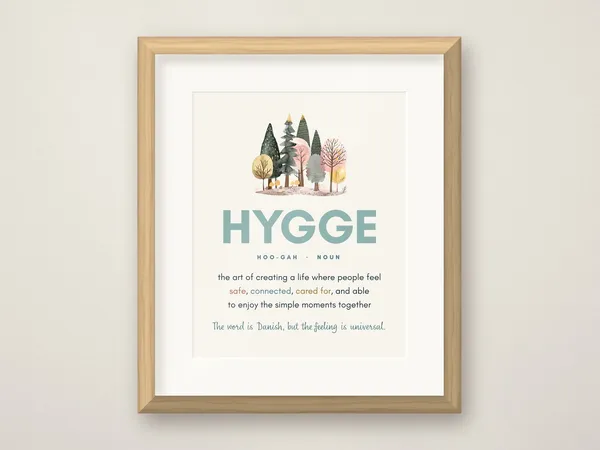 The Hygge definition print with watercolor trees in a honey oak frame